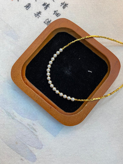 Shiny golden small pearl necklace